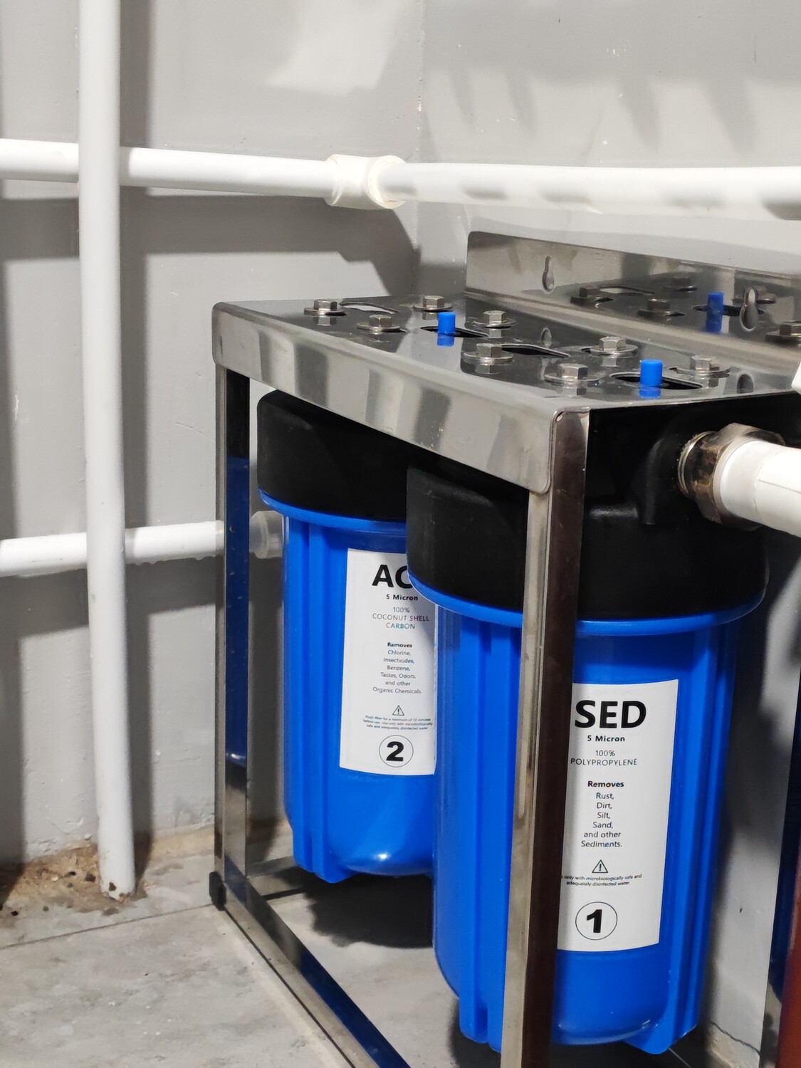 A whole-home water filtration system on a metal frame.